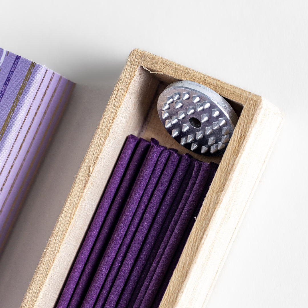 Soothing Lavender Incense in a light wooden box with deep purple sticks, elegantly packaged in a lavender-toned design featuring white circular patterns for a calming ambiance.