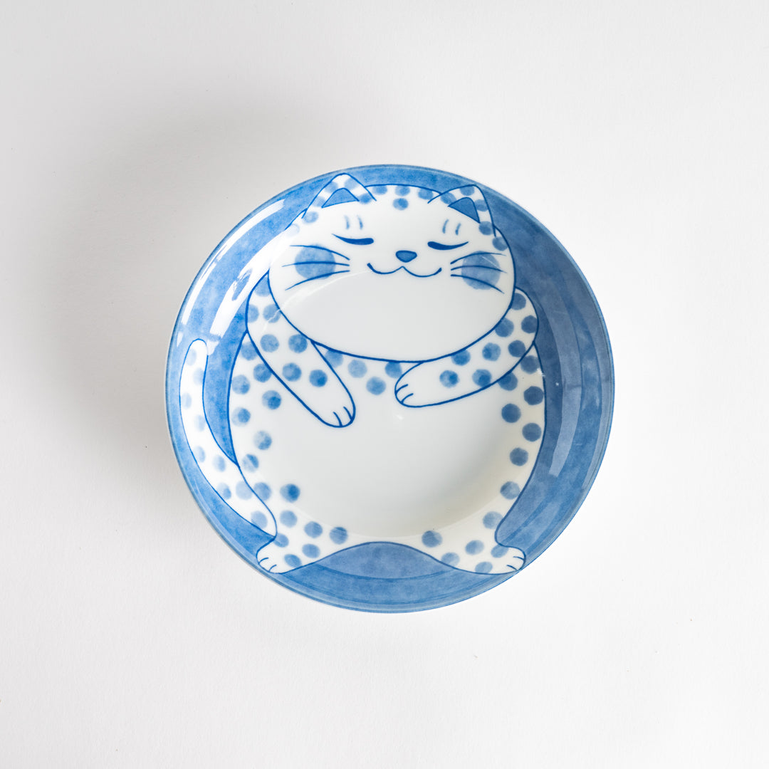 A salad plate featuring a chubby blue-spotted white cat with a contented expression.