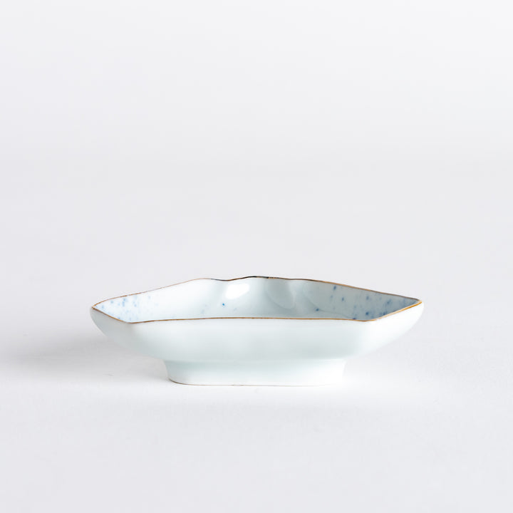 Side view of the mini sauce dish shaped like Mount Fuji, featuring blue speckles and a delicate gold rim along the edges.