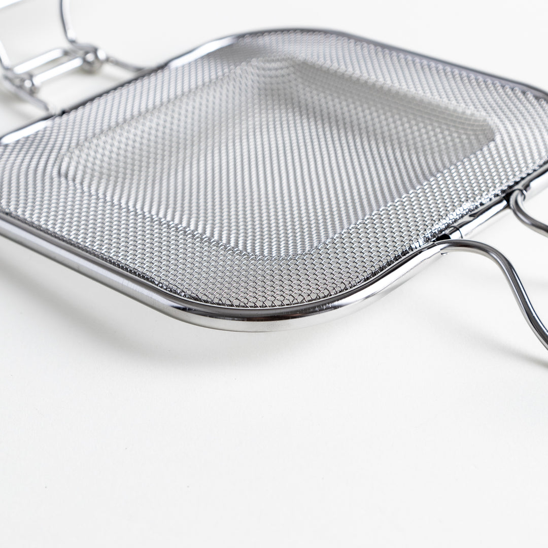 Close-up of the griller’s mesh surface, emphasizing the fine stainless steel weave.