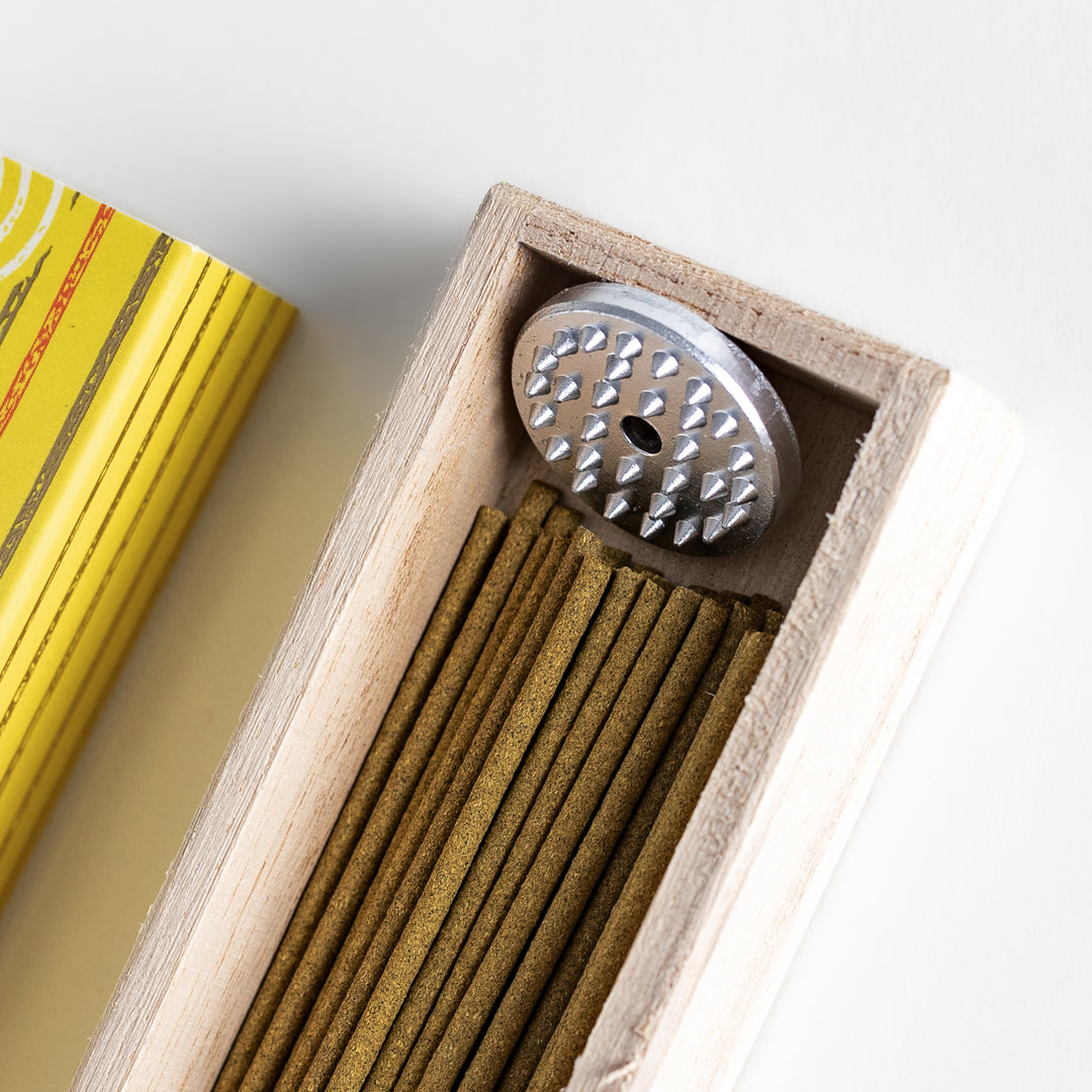 Sunny Lemon Incense in a light wooden box with golden-yellow sticks, elegantly packaged in a vibrant yellow design featuring white circular patterns, evoking a bright and refreshing citrus aroma.