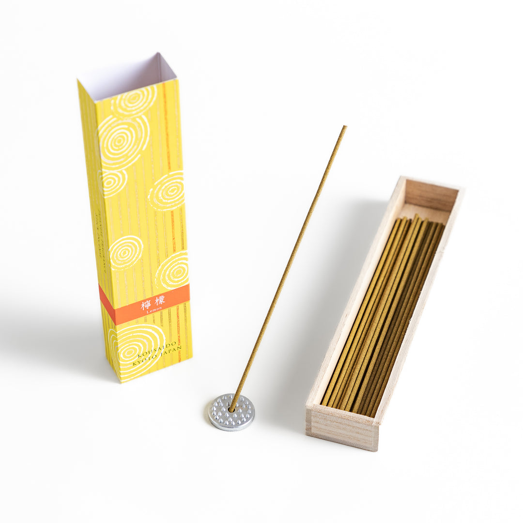 Sunny Lemon Incense in a light wooden box with golden-yellow sticks, elegantly packaged in a vibrant yellow design featuring white circular patterns, evoking a bright and refreshing citrus aroma.