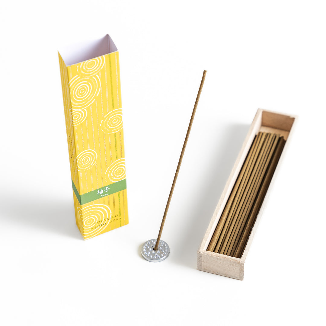 Zesty Yuzu Incense in a light wooden box with golden-yellow sticks, elegantly packaged in a vibrant yellow design featuring white circular patterns, evoking a bright and citrusy yuzu aroma.