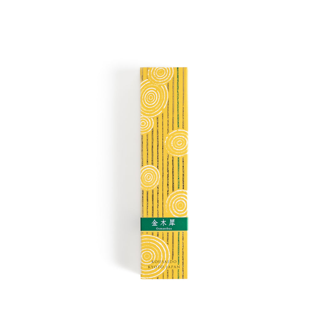 Incense in a light wooden box with warm brown sticks, elegantly packaged in a vibrant yellow design featuring white circular patterns for a refreshing and uplifting ambiance.