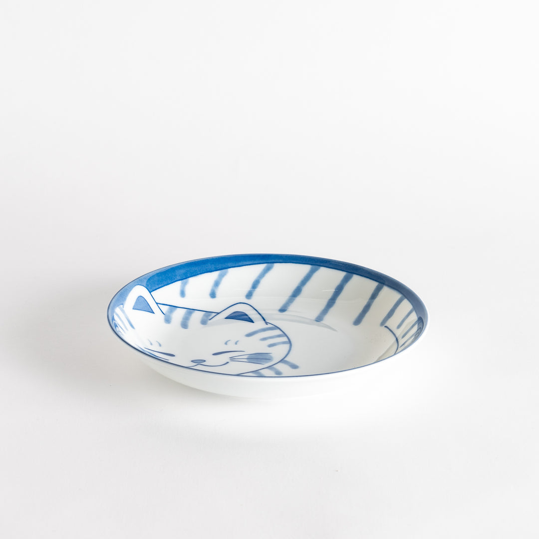 A salad plate with a blue-striped white cat, smiling with closed eyes.