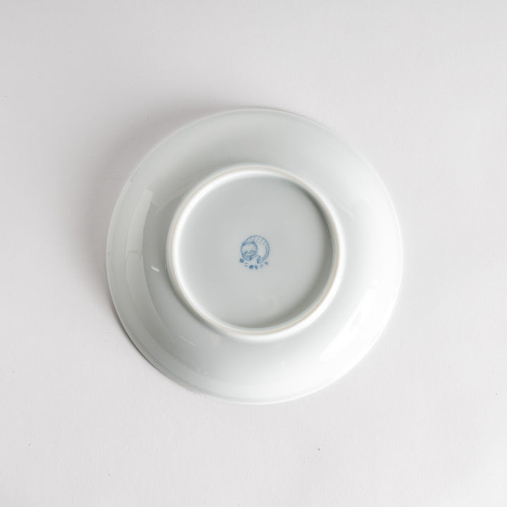 A salad plate with a blue-striped white cat, smiling with closed eyes.