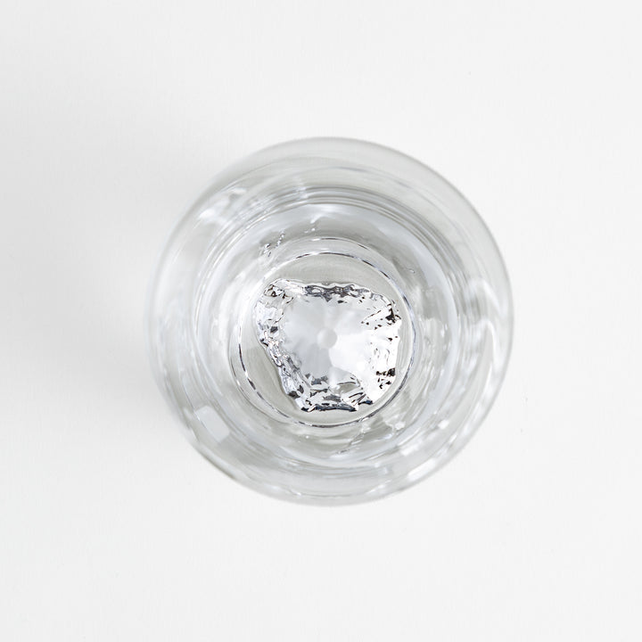 The top-down view of the glass, surrounded by a geometric etched pattern.