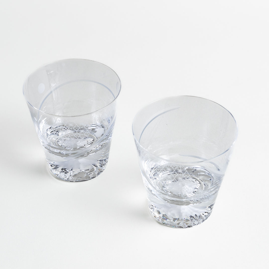 Two glasses showing etched designs and a mountain-shaped base.