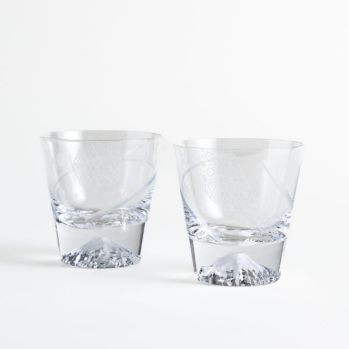 Two glasses with etched designs. The glasses feature a delicate geometric pattern and a mountain base.