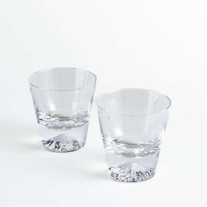 Two rocks glasses showing sakura engravings and Mt. Fuji design at the base, offering a refined, intricate detail.