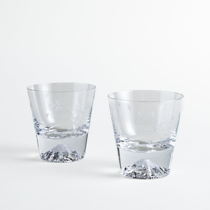 Pair of sakura-etched rocks glasses featuring a clear Mt. Fuji motif at the base, elegantly showcased for a stylish presentation.