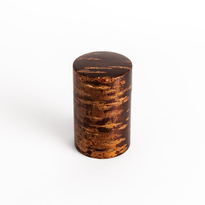 Traditional Japanese tea caddy crafted from cherry bark with a rich, warm brown hue and natural grain, perfect for storing and preserving precious tea leaves.