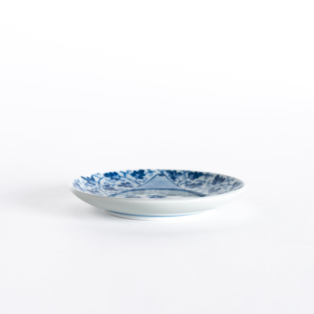 Side view of the three-sided sauce dish, showcasing its unique triangular shape and beautiful blue floral arabesque design.