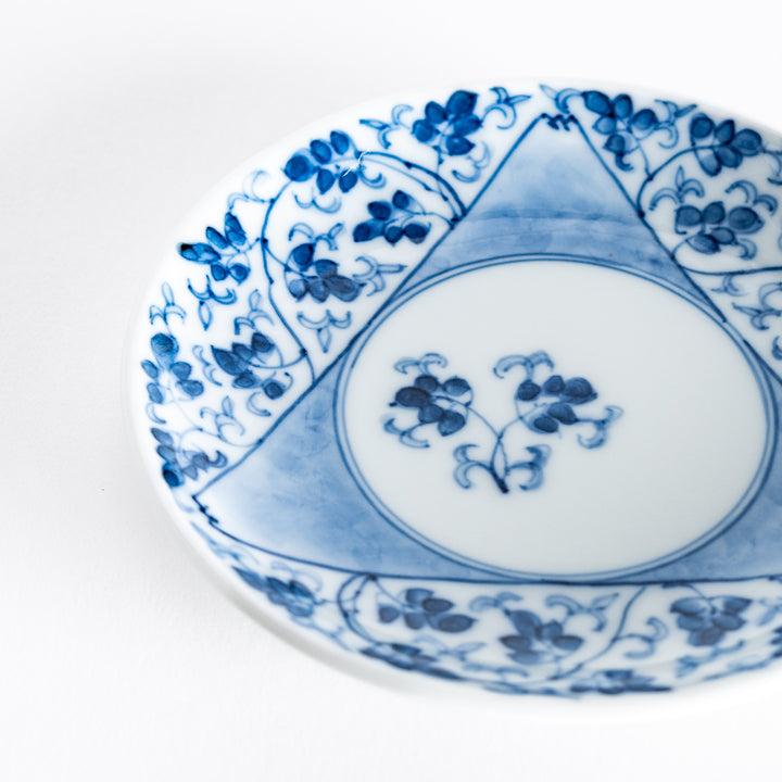 Close-up of the blue arabesque floral pattern on the three-sided sauce dish, with a circular center featuring a minimalist flower design.