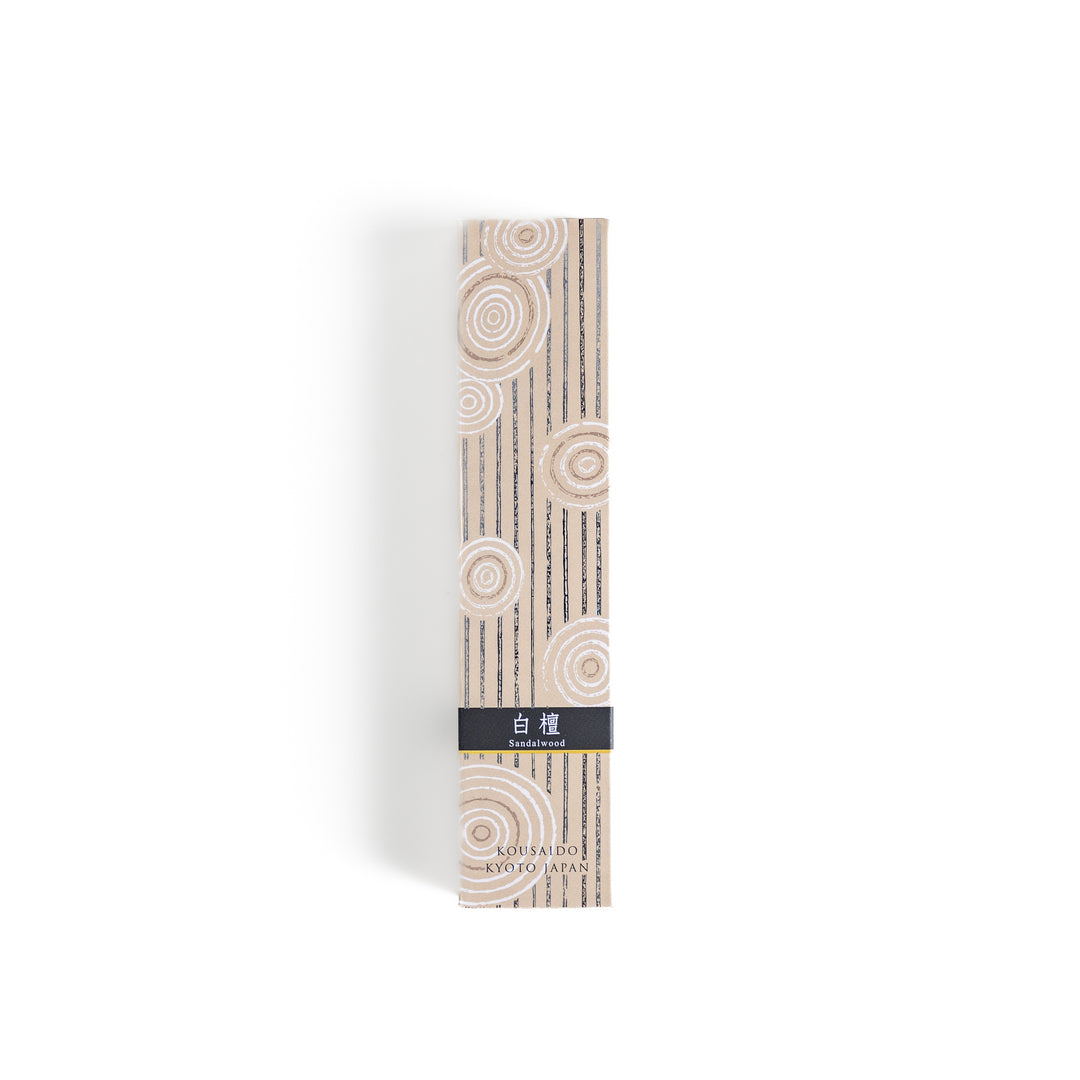 Timeless Sandalwood Incense in a light wooden box with warm brown sticks, elegantly packaged in a soft beige design featuring white circular patterns, evoking a classic and soothing sandalwood aroma.