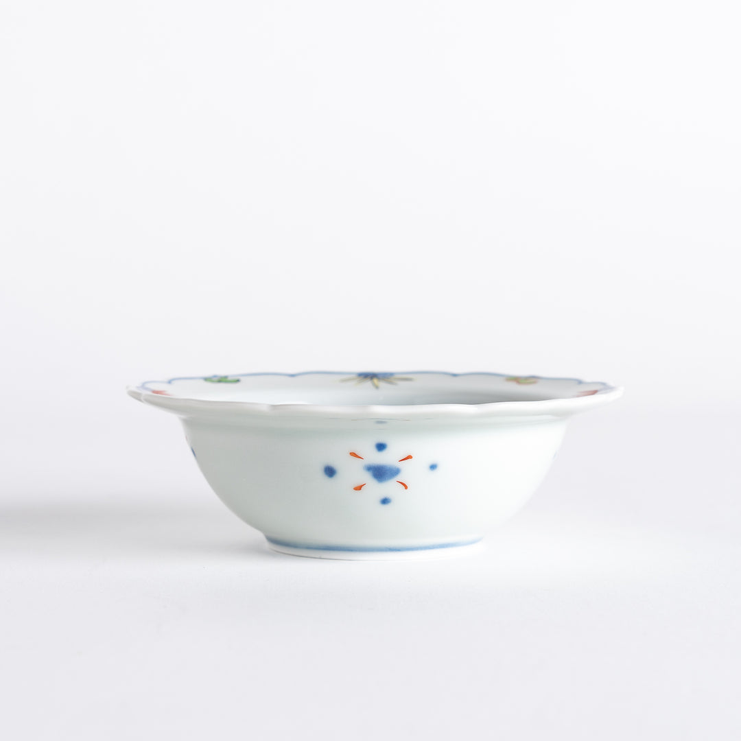 A porcelain bowl with colorful geometric patterns and floral motifs on the interior.