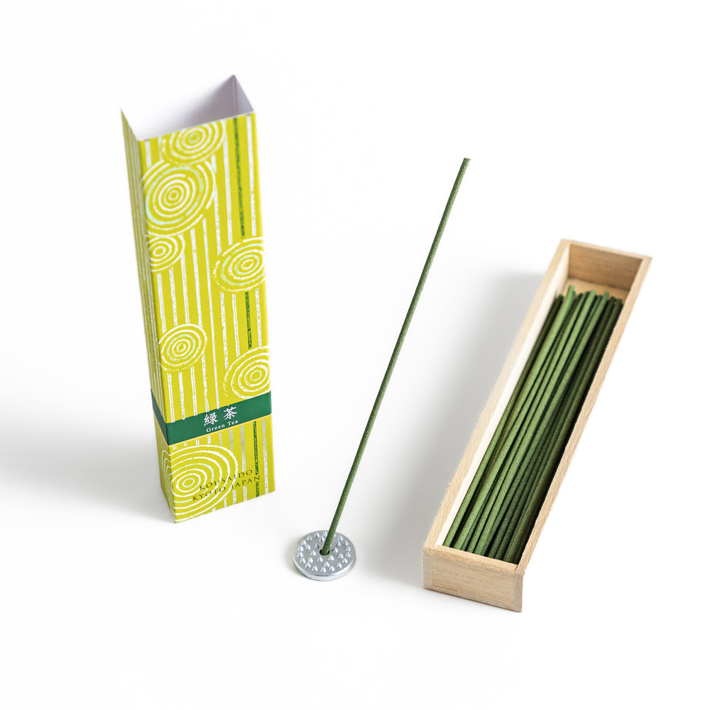 Tranquil Matcha Incense in a light wooden box with vibrant green sticks, elegantly packaged in a yellow design featuring white circular patterns, evoking the calming aroma of green tea.