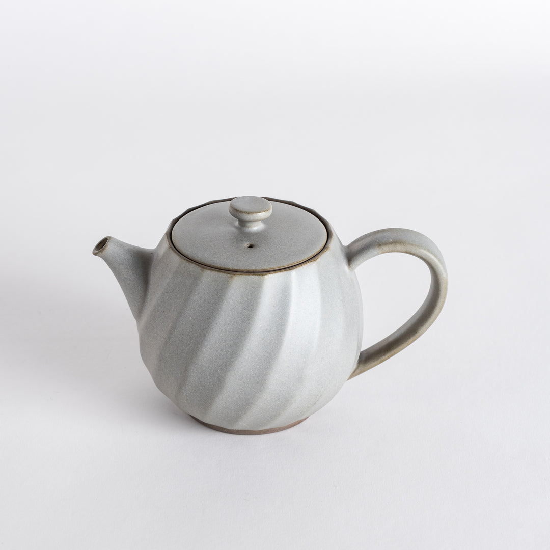 Elegant teapot with a swirling design, adding a unique touch to your tea-drinking experience. Ideal for serving tea.