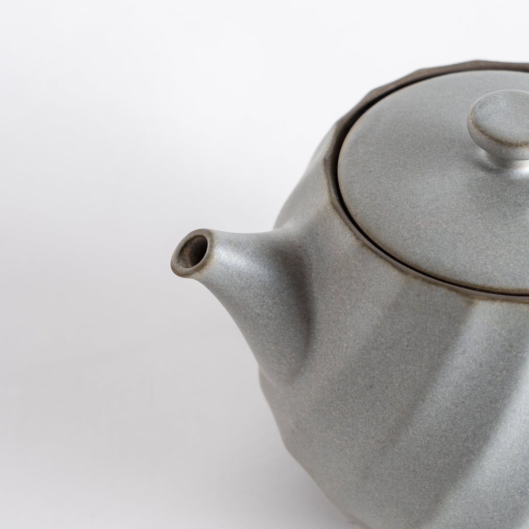 Close-up of the teapot's lid, showcasing the detailed craftsmanship and sleek design for a refined look.