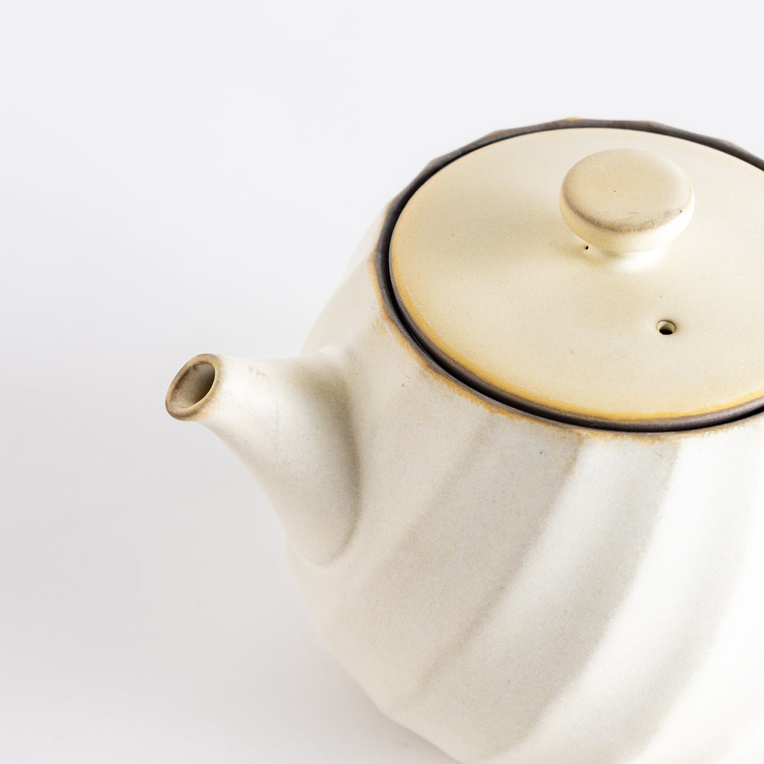 Another angle of the teapot, displaying its smooth texture and classic design, ideal for tea enthusiasts.