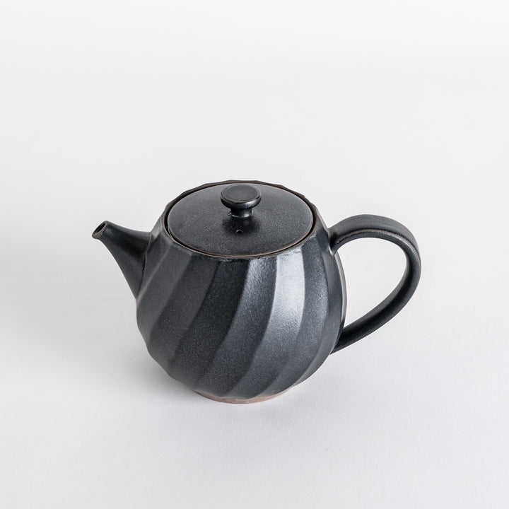 Elegant black teapot featuring a twisted design, perfect for adding style to your tea service.