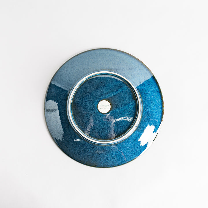 A round dinner plate with a deep blue gradient finish and a subtle textured surface.