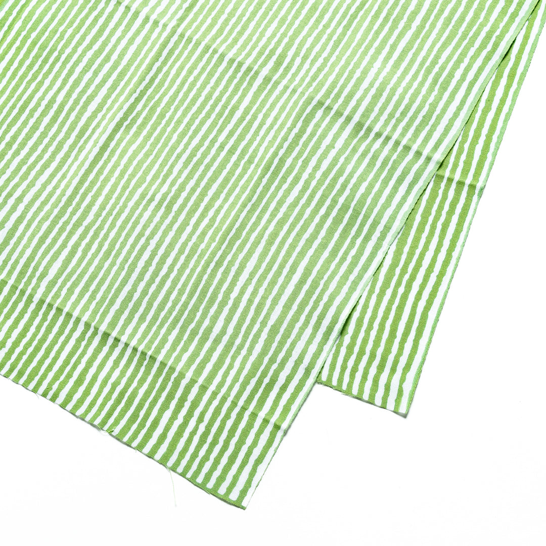 Close-up of the green hand towel's vertical white stripe pattern.