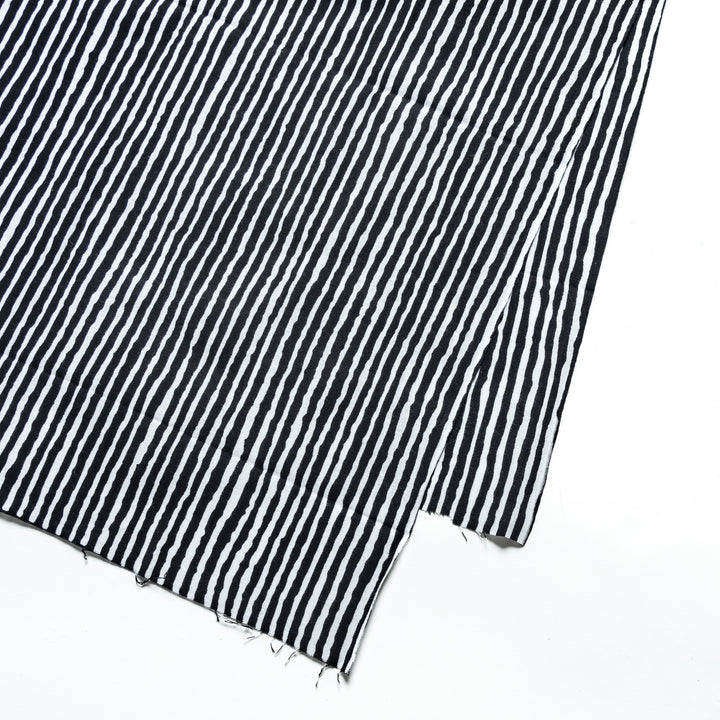 Close-up of the black hand towel's vertical white stripe pattern.