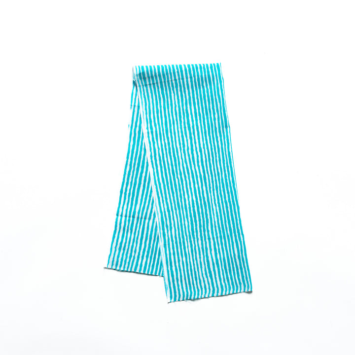 Bright blue hand towel with vertical white stripes, folded neatly.