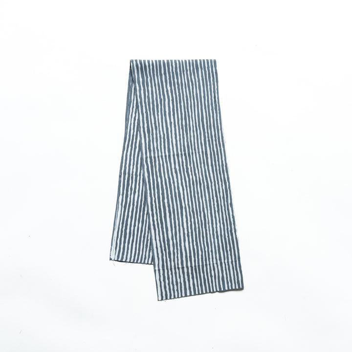 Gray hand towel with vertical white stripes, folded neatly.