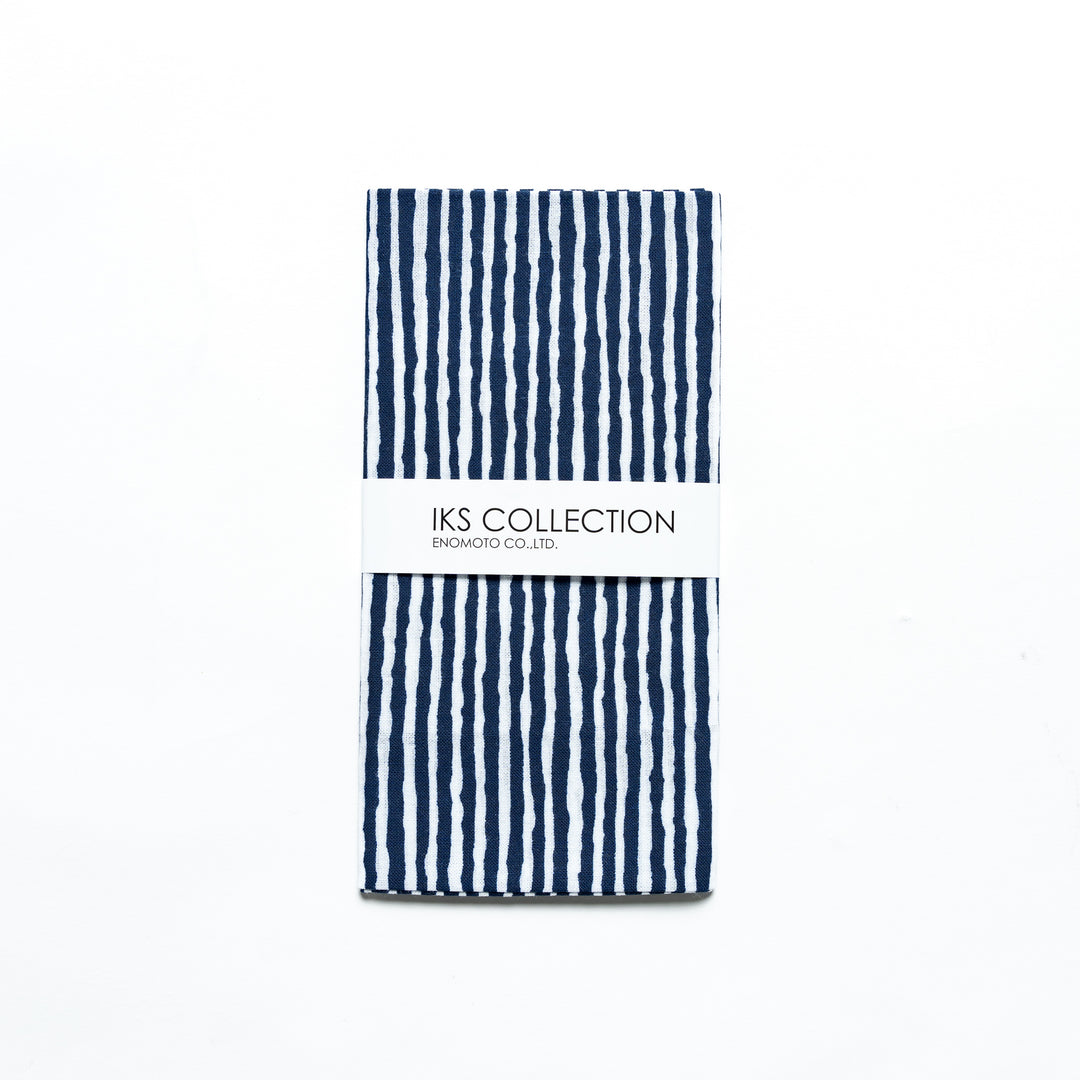 Navy hand towel with vertical white stripes, folded with a product sleeve.