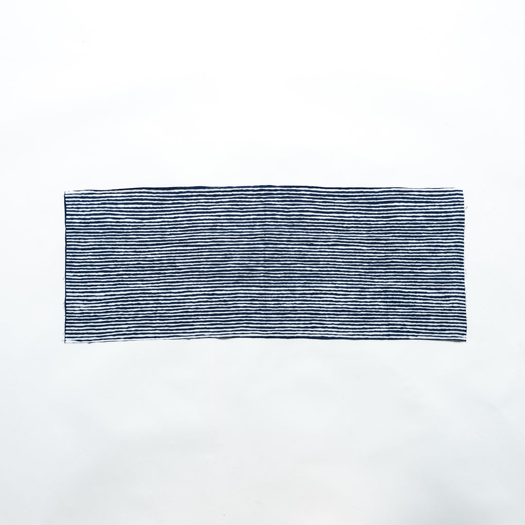 Navy hand towel with vertical white stripes, laid flat for full view.