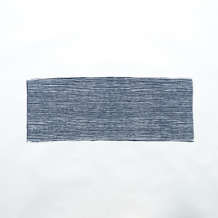 Navy hand towel with vertical white stripes, laid flat for full view.