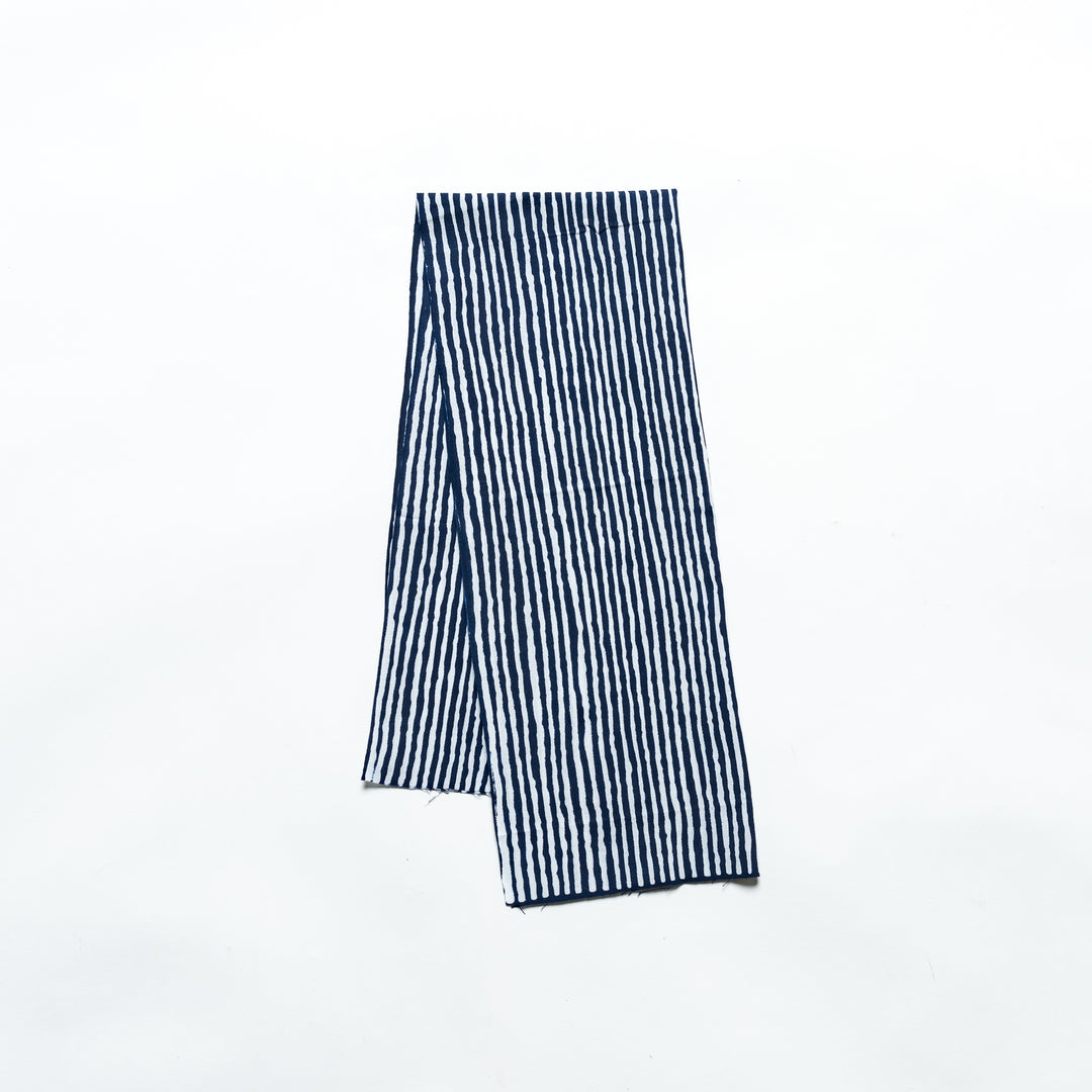 Navy hand towel with vertical white stripes, folded neatly.