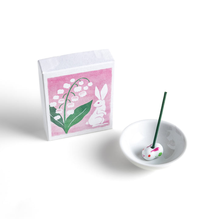 Incense featuring deep green sticks in a box decorated with an elegant lily of the valley and rabbit illustration, offering a delicate and soothing floral fragrance.