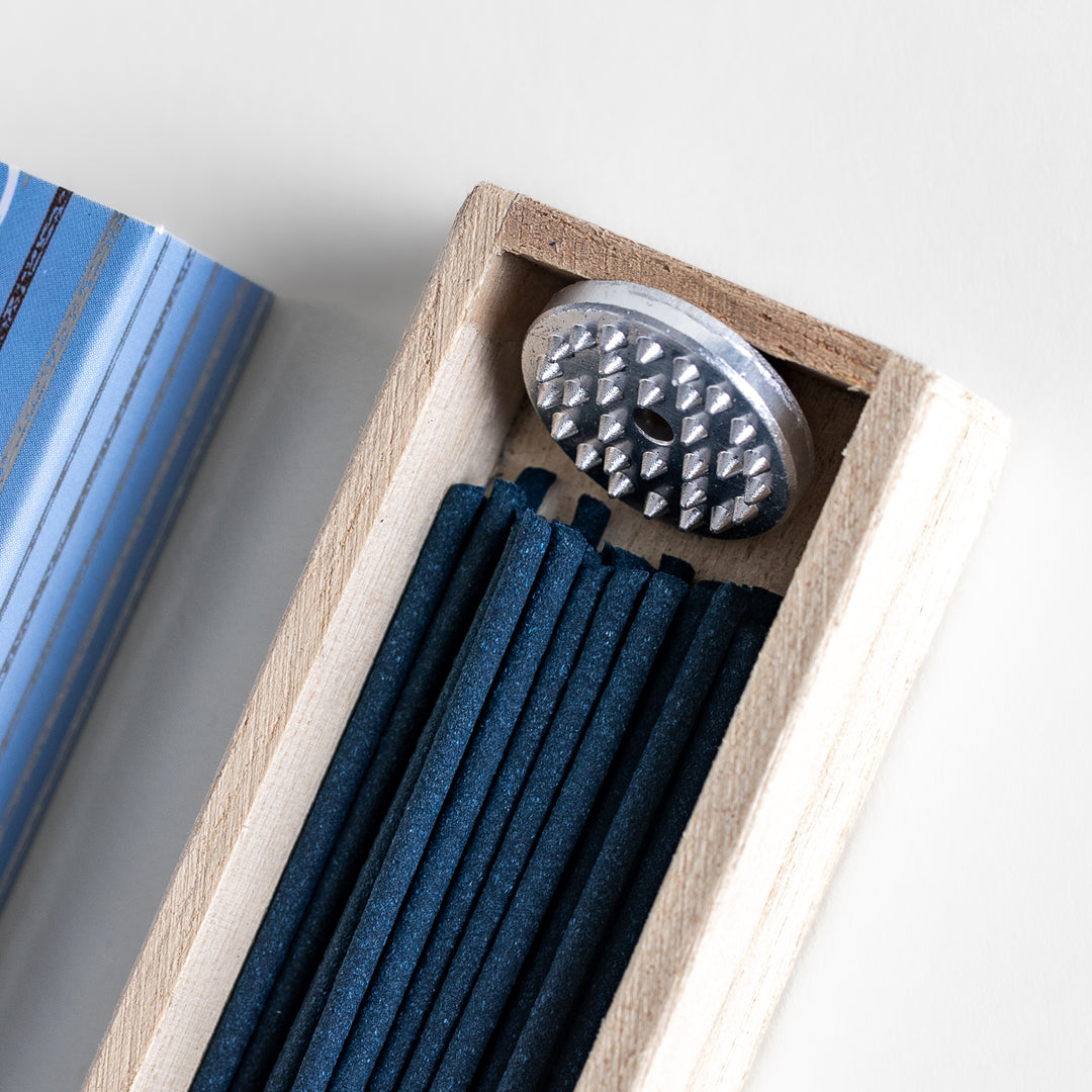 Velvet Vanilla Incense in a light wooden box with deep navy sticks, elegantly packaged in a soft blue design featuring white circular patterns, evoking a warm and comforting vanilla aroma.