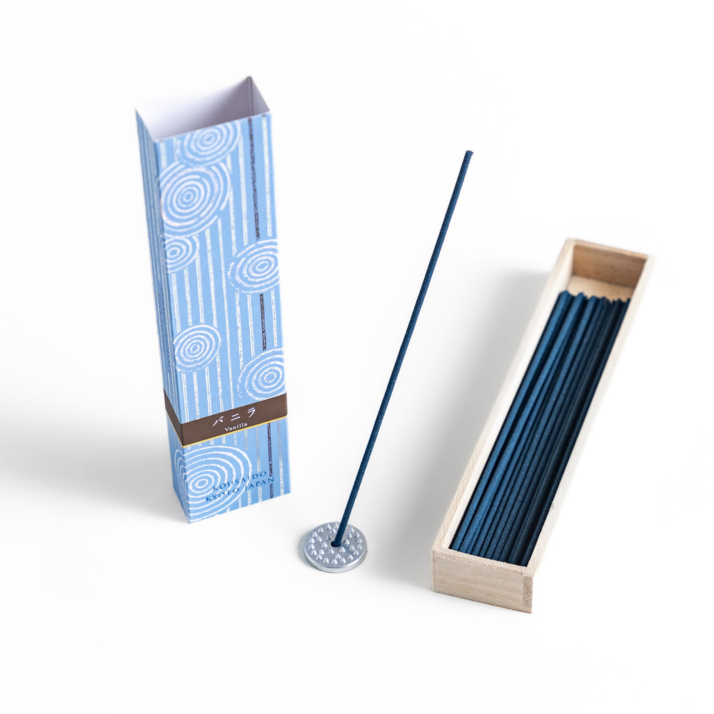 Velvet Vanilla Incense in a light wooden box with deep navy sticks, elegantly packaged in a soft blue design featuring white circular patterns, evoking a warm and comforting vanilla aroma.