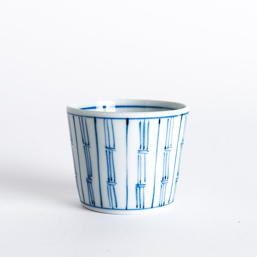 White bowl with blue vertical bamboo line pattern, showcasing the clean, minimalist design of the bowl.