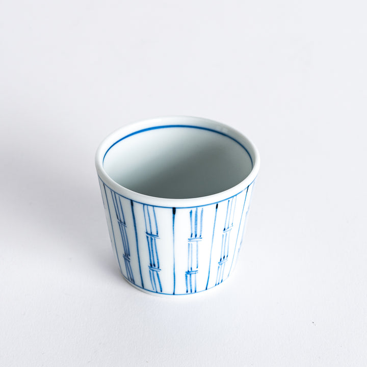 Diagonal view of the blue vertical bamboo line patterned bowl, showcasing its design.