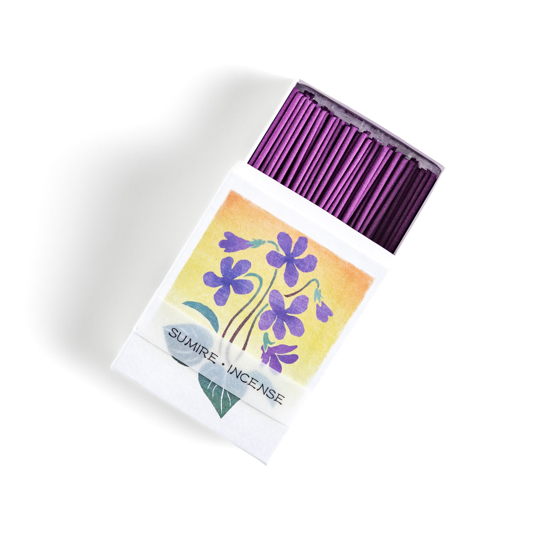 Incense featuring deep violet sticks in a box adorned with a delicate violet flower illustration, offering a floral and soothing fragrance for relaxation.