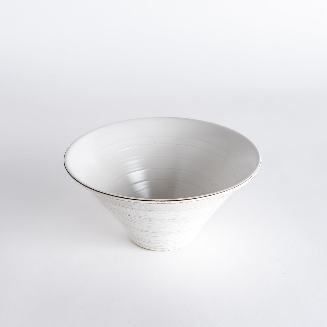 Top-down view of the white bowl, featuring the intricate spiral texture along the rim and a clear base.