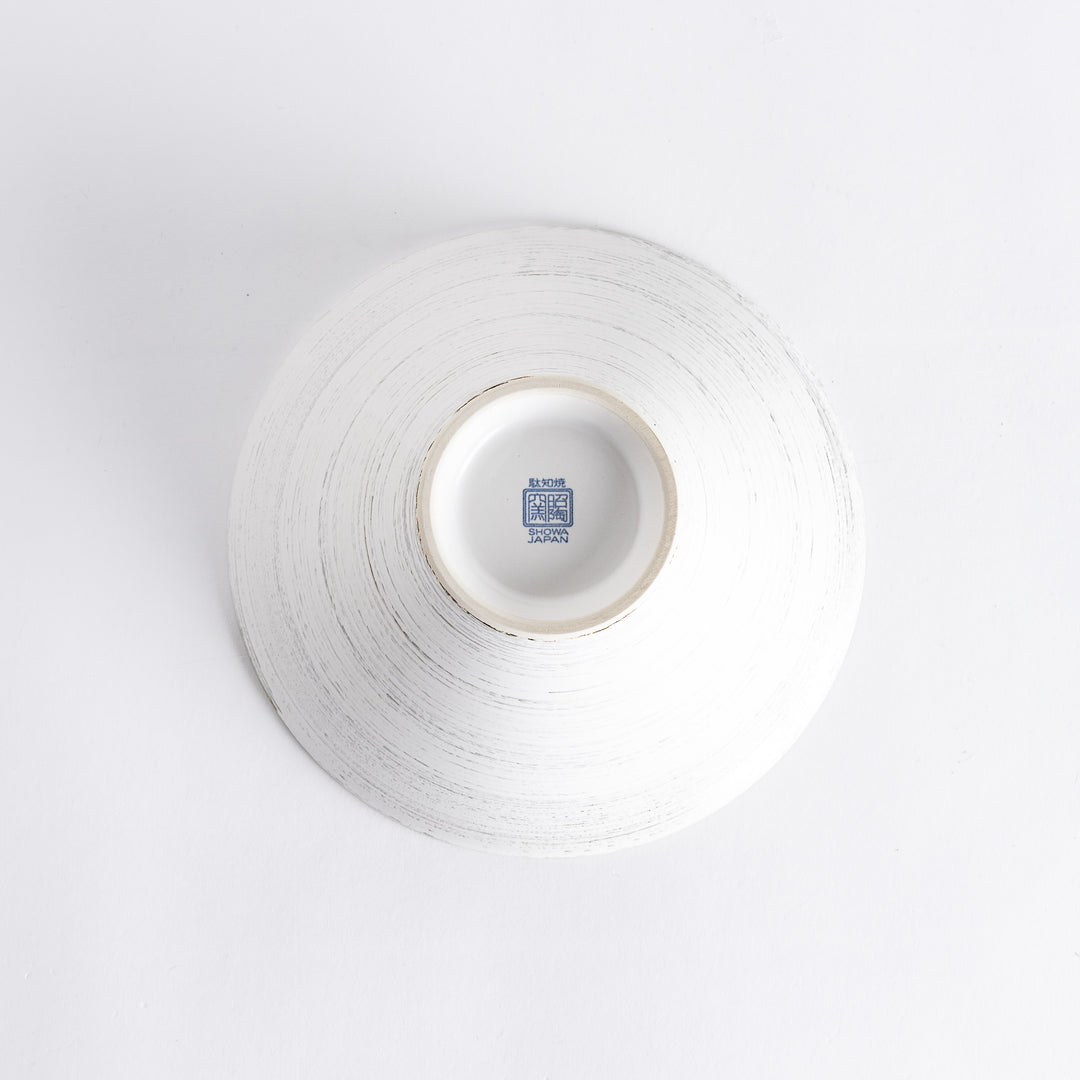 Underside of the white spiral flared ramen bowl, revealing a smooth surface with a subtle spiral texture and a blue manufacturer's mark in the center.