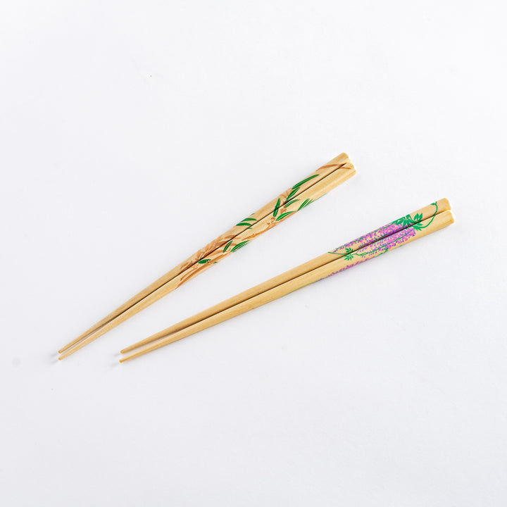 Chopsticks featuring delicate bamboo and wisteria motifs in green and purple hues. Paired with a transparent stand for display.