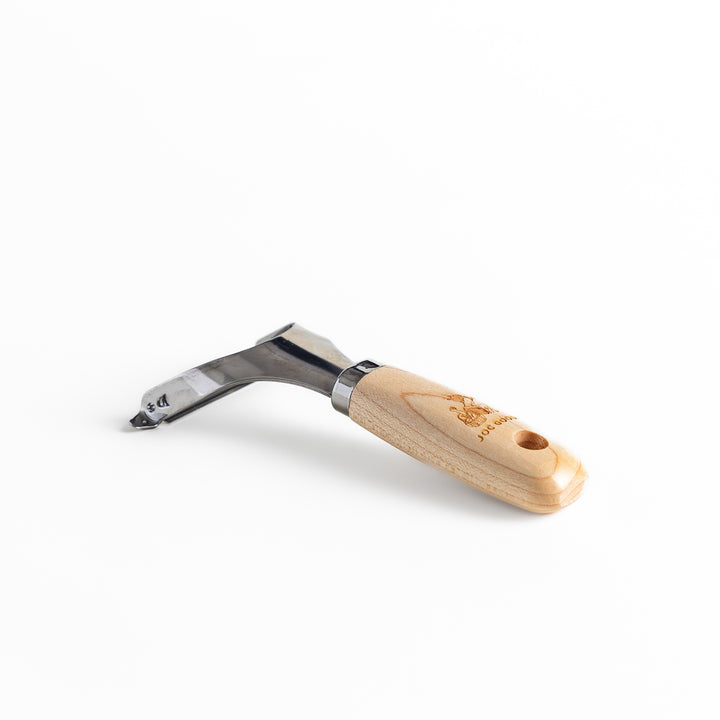 Japanese Wood Handle Peeler, a functional kitchenware with a stainless steel blade and ergonomic wooden handle, ideal for effortless vegetable peeling.