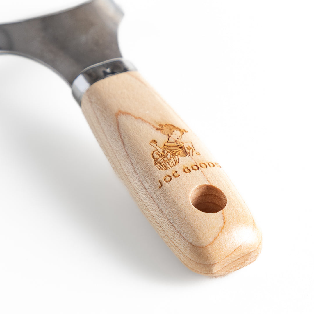 Wooden-handled julienne peeler with sharp stainless steel blade, featuring the JOC Goods logo, perfect kitchenware for vegetable strips.