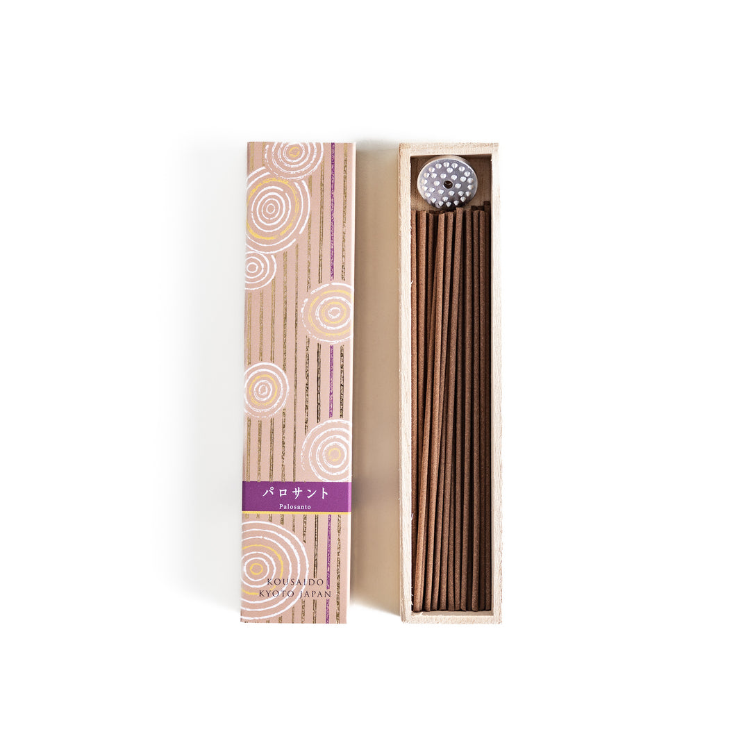 Woodland Palo Santo Incense in a light wooden box with warm brown sticks, elegantly packaged in a soft beige design featuring white circular patterns, evoking a calming and purifying Palo Santo aroma.