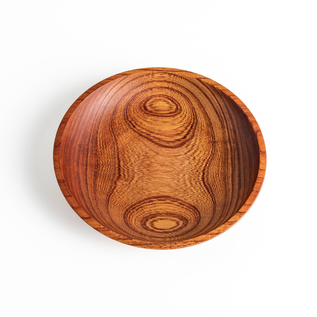 A top-down view of a Zelkova wood salad plate, highlighting its smooth surface and natural, beautiful wood grain.