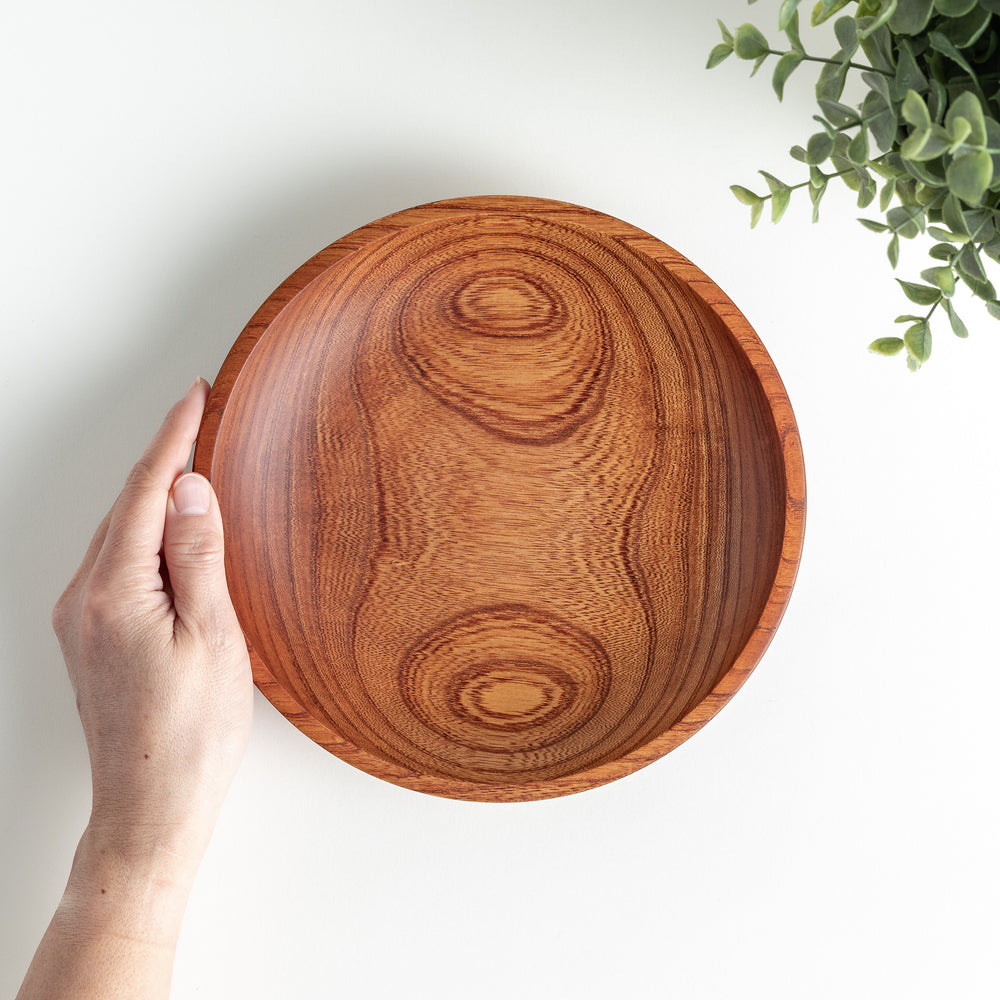 Viewed from a slight angle, highlighting its natural wood grain and smooth curved edge.