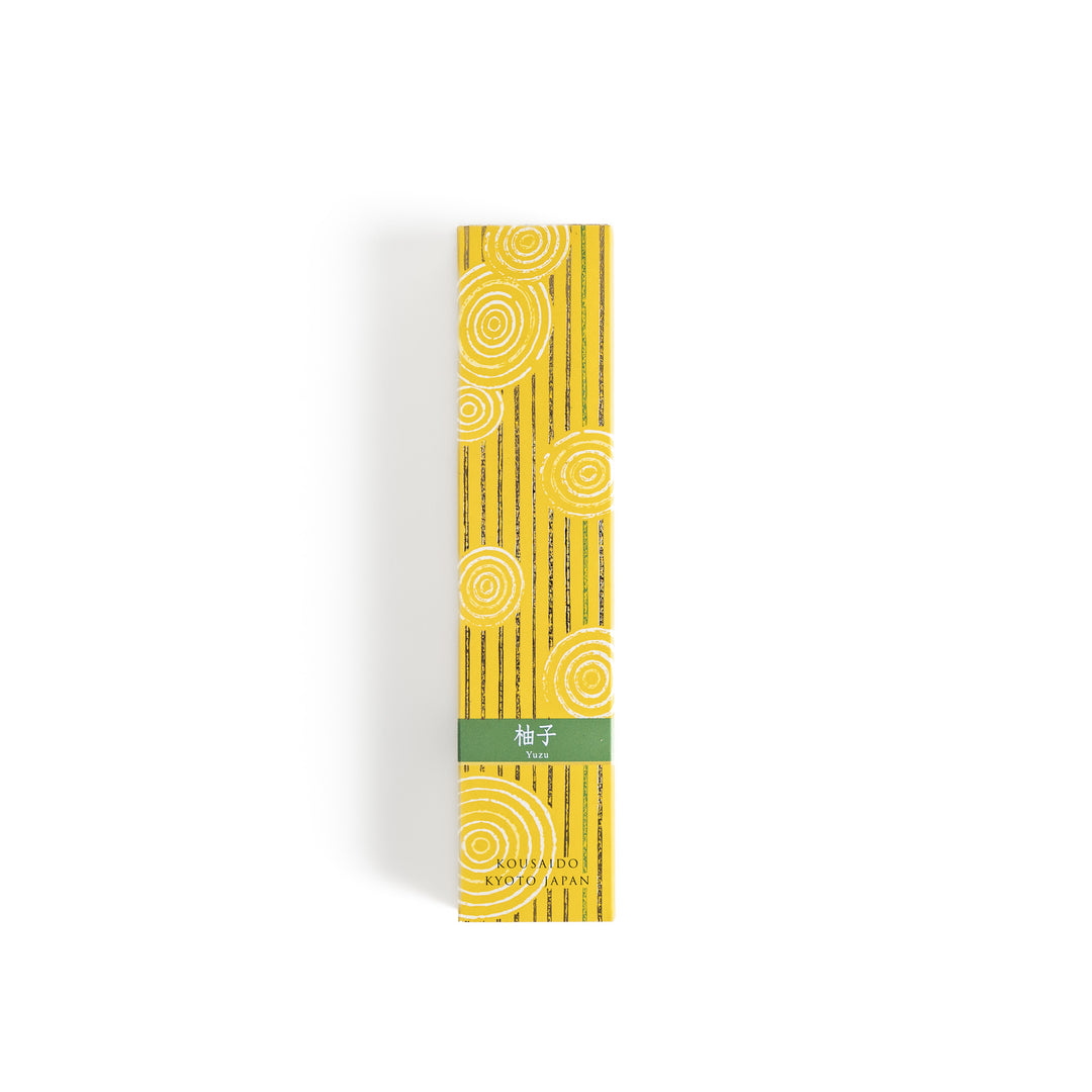 Zesty Yuzu Incense in a light wooden box with golden-yellow sticks, elegantly packaged in a vibrant yellow design featuring white circular patterns, evoking a bright and citrusy yuzu aroma.