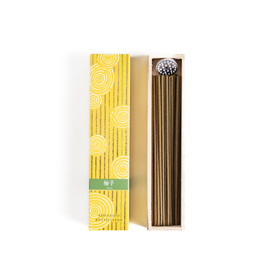 Zesty Yuzu Incense in a light wooden box with golden-yellow sticks, elegantly packaged in a vibrant yellow design featuring white circular patterns, evoking a bright and citrusy yuzu aroma.